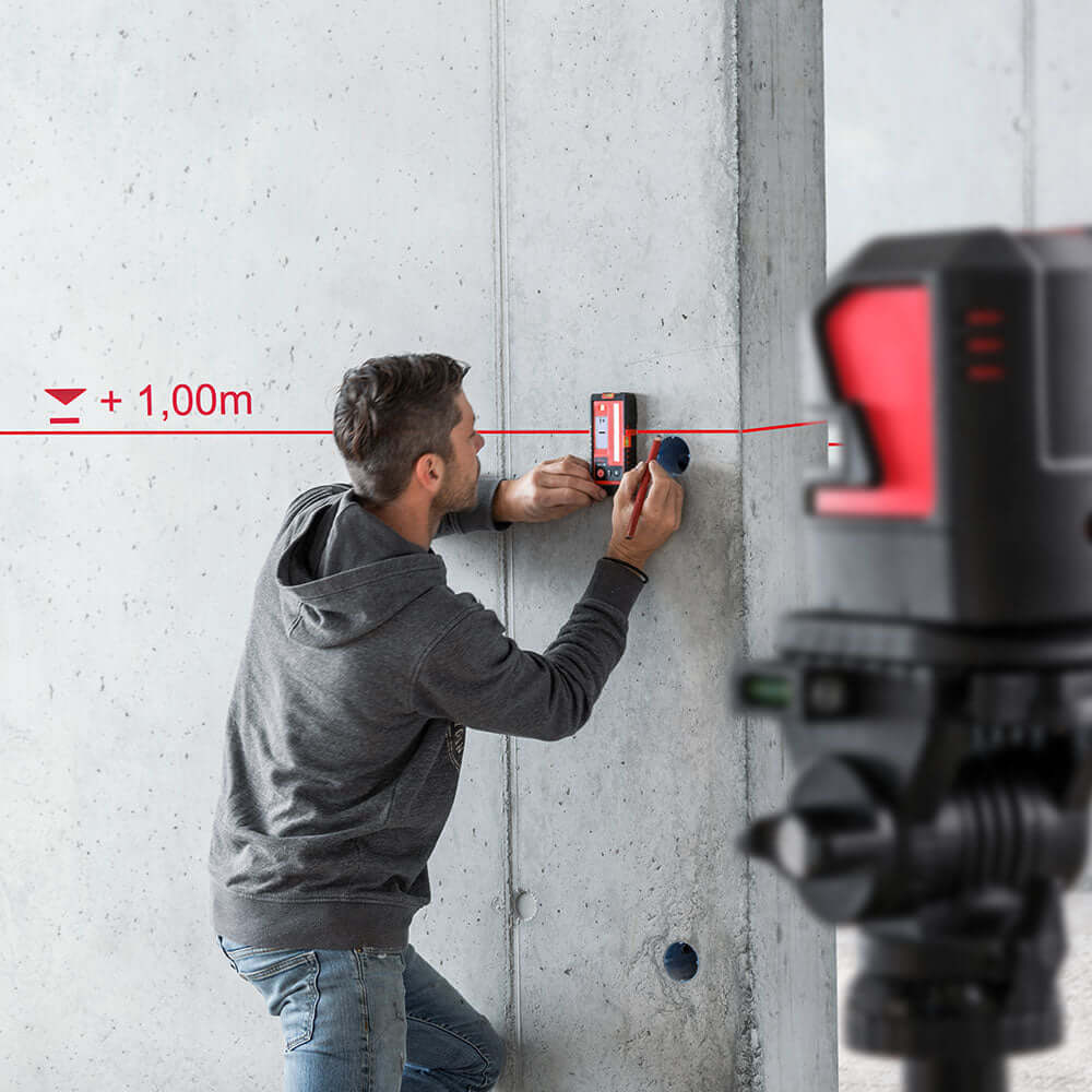 Professional using distance measuring instruments on a construction site for accurate measurements