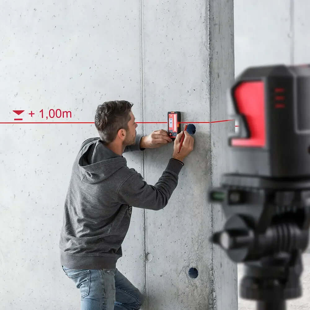 Professional using distance measuring instruments on a construction site for accurate measurements