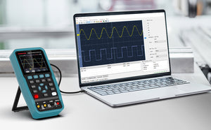 Oscilloscope and laptop displaying waveforms on a desk